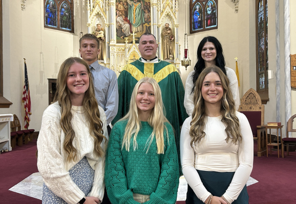 Pictured left to right: (Front row): Samantha Stuhr, Brooke Kinney, Elizabeth Moser. (Back row): Gavin Kallhoff, Father John Norman, Aubrie Parks