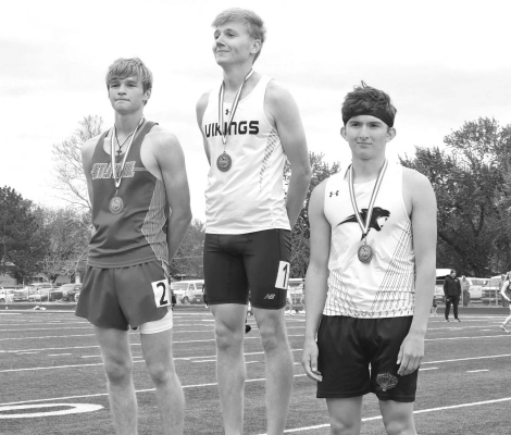 Micah Cuevas (at right) on the podium with his medal.