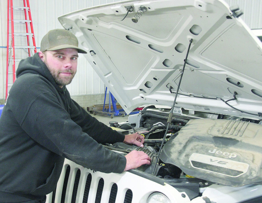Dan Henn works on several Jeeps that were in his shop last week.