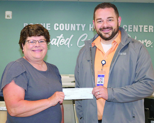 BOONE COUNTY Health Center received $500 for mammography equipment. CPPD trustee Cindy Hemmer (left) presents the check is BCHC President and CEO Caleb Poore.