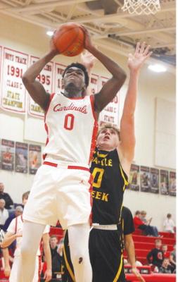 Cardinal senior Jaxon Lipker gets inside a Battle Creek defender to score in Boone Central’s 59-56 victory over the Braves Friday. (Photo, Karla Patzel )