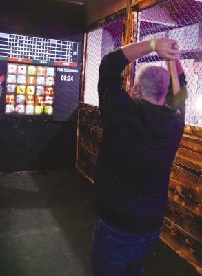 NEW BUSINESS OPENS -- ‘The Nest’ in Albion was opened last Friday evening, Feb. 2, at Fourth and Main Streets by owner Ray Barnes. Axe throwing (as demonstrated by Ron Harris, above) was one of the featured activities, along with other games and karaoke.