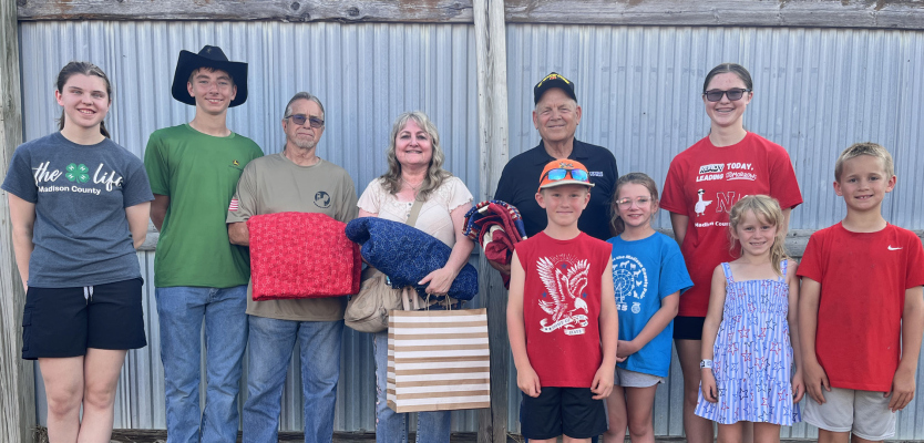 Madison County 4-H members presented the Quilts of Valor at the Madison County Fair and Rodeo. From left Ali Schmidt, Franklin Polacek, Michael Knull, Bernice Brown, Dennis Kuchar, Darren Grant, Kinsley Reeves, Jaylynn Schmidt, Emma Grant, and Luke Grant.