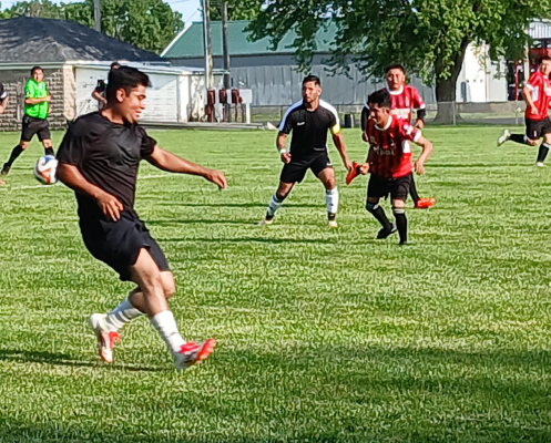 Locals playing in their first soccer game in St. Edward.