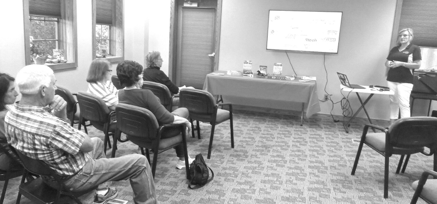 Humanities Nebraska speaker Jody Lamp (standing) presented a discussion of her book “A History of Nebraska Agriculture: A Life Worth Living” to patrons of the St. Edward Public Library.