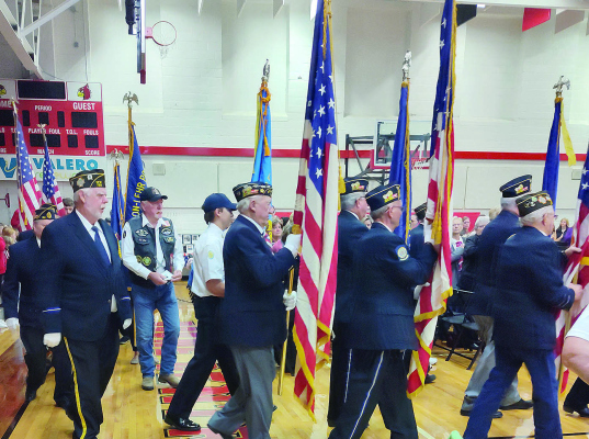 LOCAL VETERANS advance the Colors to begin the Veterans Day ceremonies at the Boone Central Gym on Monday.
