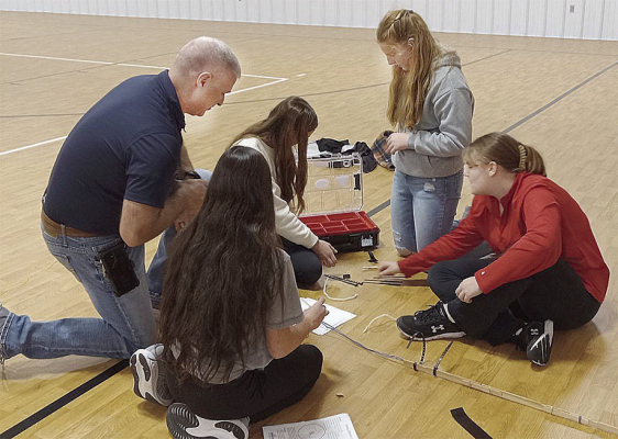 NUCLEAR LEARNING -- Jon Schulte, Energy Education Lead from Nebraska Public Power District, answers questions from a team of students participating in the nuclear refueling challenge hosted by NPPD and the St. Edward Public Library.