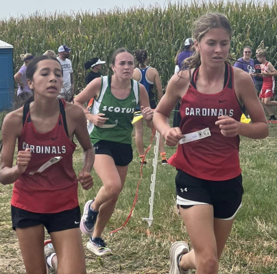 Boone Central Junior High athletes, Margo Martinez and Josie Rother run stride for stride with the leader.