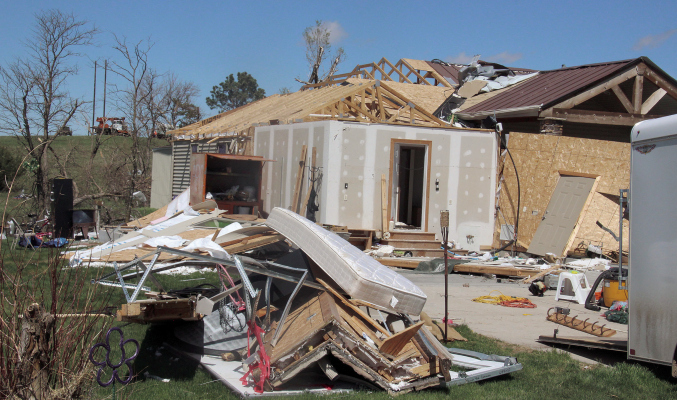 Worst damage to a home occurred at the Tracy Paulsen farm southwest of Primrose. Crews from Nebraska Public Power District and Cornhusker PPD were on hand (upper left) to repair extensive damage to a main transmission line crossing through the property. More photos on page 16.