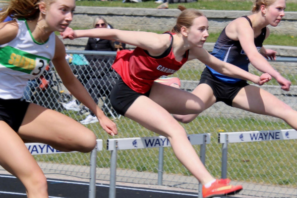 With her eyes on the finish line, Sophie Lyon, competes in the 100m High Hurdles at the Wayne Invitational. She finished in 3rd.