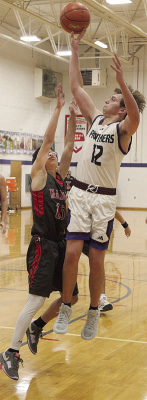 UP FOR TWO -- Parker Fitchner of Newman Grove-St. Edward (12) shoots over a Madison defender in last week’s five-point loss.