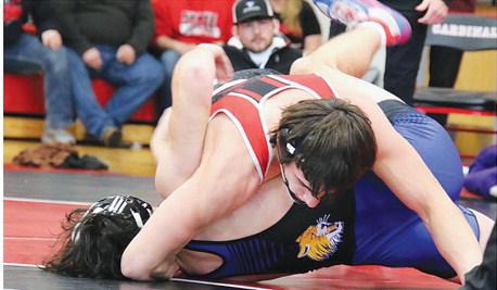 Boone Central junior Thomas Roberts nears a pin during a busy week of Cardinal wrestling. Roberts (190) won both of his matches in a triangular vs. Lakeview and Scotus, took gold in the Gibbon Bill Foster Invitational and was runner-up in the Boone Central Dale Bonge Invitational. (Photo, Rose Buhlmann )