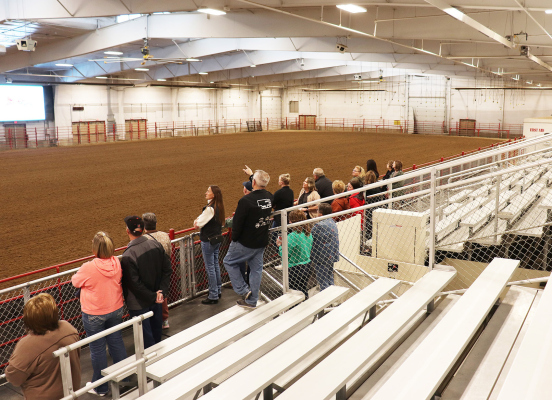 Manager Chuck Rolf (middle) shows guests the multi-purpose livestock exposition and show arena, which has hosted concerts, auctions, livestock shows, rodeos, barrel racing and roping competitions.