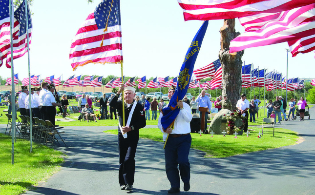FLAG BEARERS retire the colors after the Memorial Day ceremony at Evergreen Cemetery, St. Edward, on Monday morning.