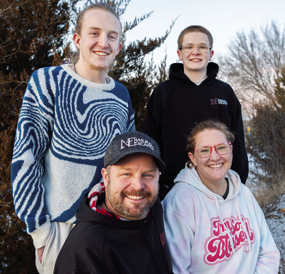 TRYING TO HELP --The Koch family. From left: Hudson, 17, Jeremy, 41, Asher, 14 and Bailey, 39. The family, posing for a portrait outside their home near Eustis on Jan. 26, 2024, has long struggled with mental health issues. The family has found healing by sharing their story online through a Facebook page it created in 2014. Since then, Anchoring Hope for Mental Health has added more than 10,000 followers who routinely share their own stories of mental health. Photo by Chris Bowling/Flatwater Free Press