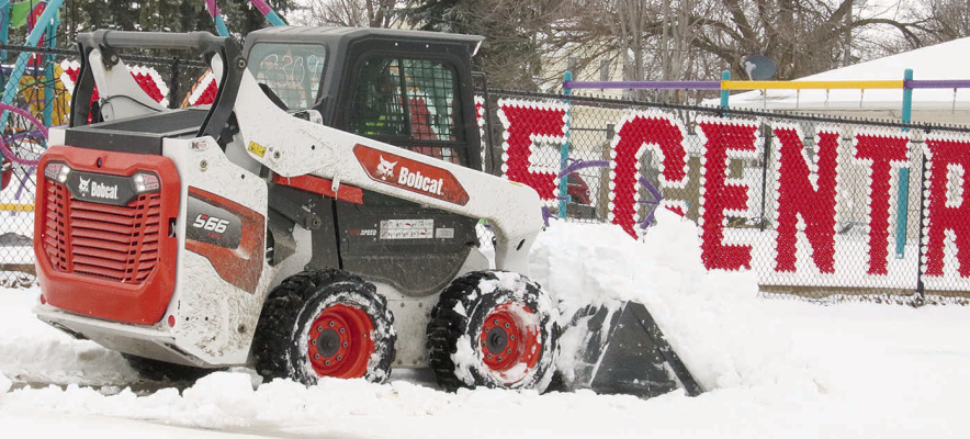 SPRING WEATHER TURNED UGLY -- Freezing rain and snow arrivied in the Boone County area on Monday, causing slick conditions and forcing several area schools to close. Above, Lowell Imus plows out a school sidewalk along Fifth Street Monday afternoon.