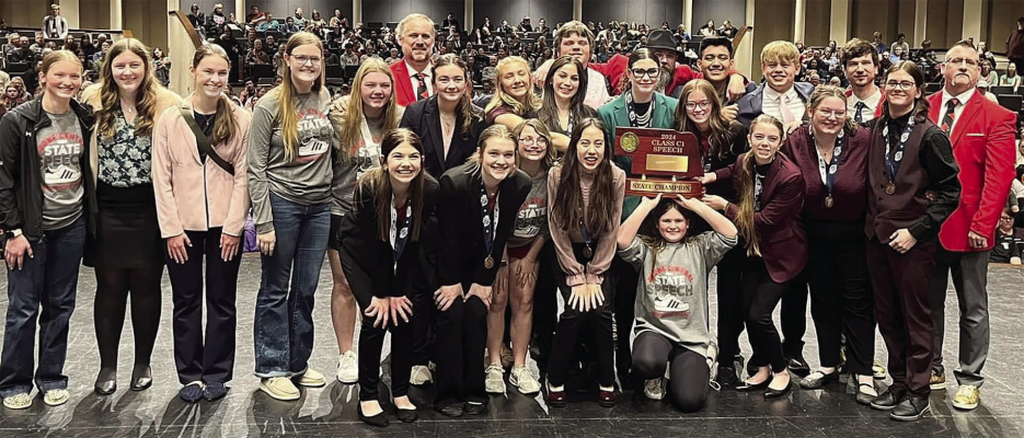 C1 STATE SPEECH CHAMPIONS: ( front, l. to r.) Brittany Sup, Jordan Patzel, Dayna Sharp, Eloise Martinez, Sydney Spangler and Katelyn Curry; (second) Edwin Naranjo, Madison Gompert, Josh Erickson, Taylor Beierman, Myranda Nelson, Nathan Devine, Emma Lordemann, Brooke Brengelman, Bella Meyer, Riley Lordemann and Coach Aaron Wyatt; (back) Coach Joel Sup, Coach Andrew Devine, Coach Curtis Luettel and Audra Groth.