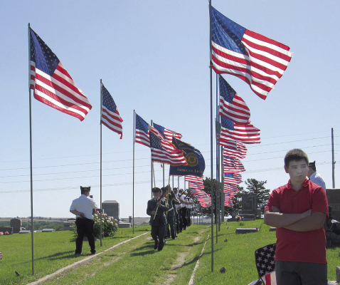 Newman Grove veterans march in to post the colors for Memorial Day ceremonies.