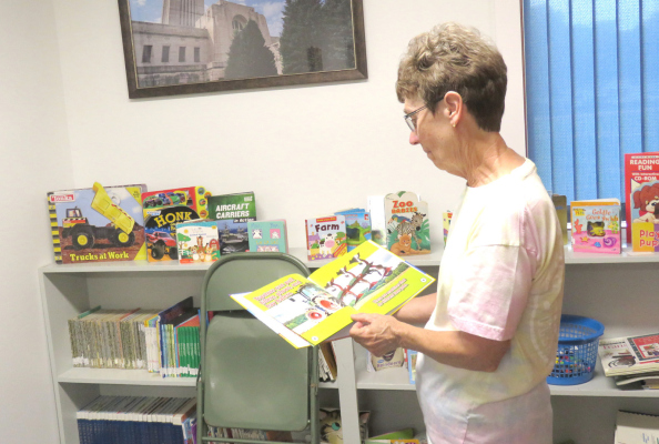 Elain Beckman Library Board member showing new children’s book