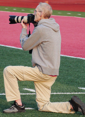 FAMILIAR POST -- Joe Flanagan shooting pictures from the sideline at a Boone Central Cardinals football game.