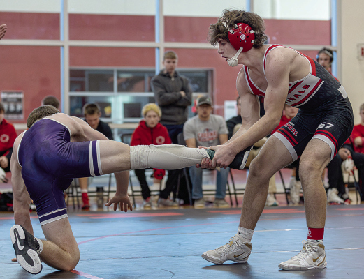 LEG DRAG -- Carterr Lueken, Boone Central’s 157-pound wrestler, brings his Minden opponent back on the mat during last Saturday’s dual tournament.