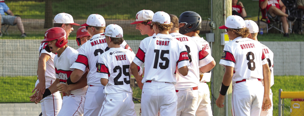 Juniors teammates celebrate with Jack Molt after his two run homer over the center field posts.