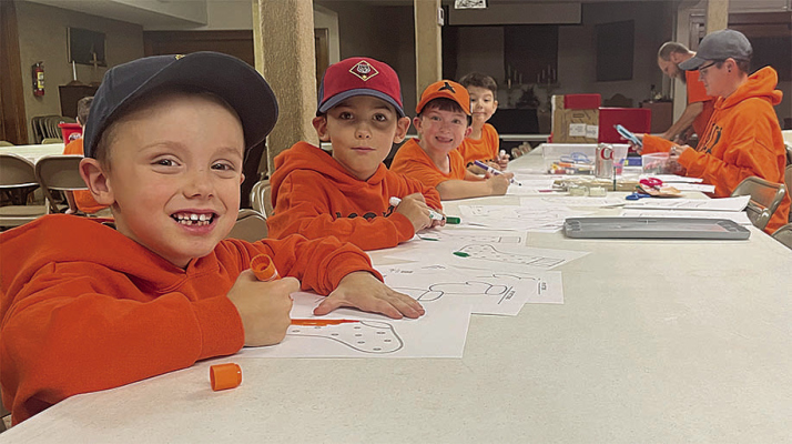 CUB SCOUTS planning their Sock Drive include (left, front to back) Cameron Lindsey of St. Edward, RJ Lindsey of St. Edward, Max Landauer of Albion, and Anthony Landauer of Albion; (right) Kayla and Robert Lindsey of St. Edward.