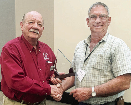 PRESENTATION -- Randy Hellbusch, left, presents the “Ross Topp Award to Jim Dresch of Primrose.
