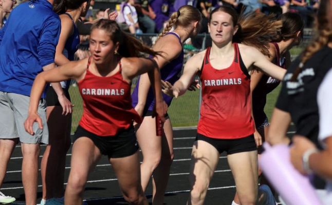 Brynna Hagemann hands off to Josie Rother in the girls’ 4x400 relay in which they placed 2nd at the Mid State Conference meet. Miss Hagemann had two big personal best to place in both the long jump and 400 meters.