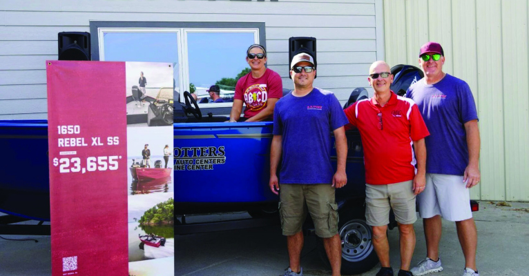 Boatload of Prizes grand prize winner Tina Thiele-Blecher (left) sits in her new Lund fishing boat at Krotter Auto and Marine on Saturday in O’Neill.
