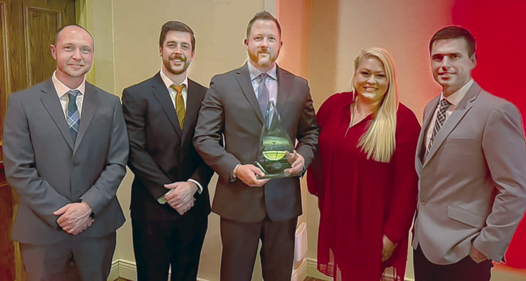 TEAM JACK AWARD -- Ed Knott (center) with the Team Jack Teammate of the Year award. Applied Connective employees are (l.-r.) Will Zoucha, Jarod Dendinger, Mandy Luettel and Eric Henn.