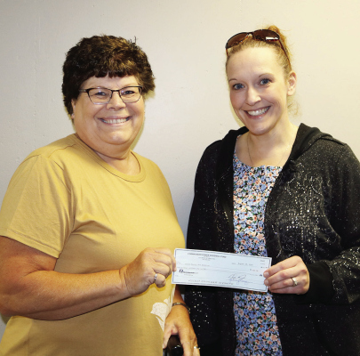 Cornhusker Public Power District trustee Cindy Hemmer (left) presents $200 to Boone County 4-H Robotics for computer cases. Accepting the check is Organizational Leader Sarah Moeller (right).