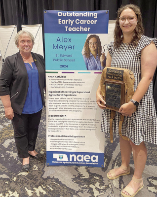 STATE AWARD -- Alex Meyer, right, with the Outstanding Early Career Teacher award presented by Jill Goedeken, left, of the University of Nebraska Alumni and Nebraska Agricultural Educators Association (NAEA).